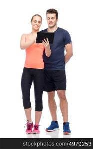 sport, fitness, technology, lifestyle and people concept - happy sportive man and woman with tablet pc computer. happy sportive man and woman with tablet pc