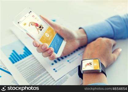 sport, fitness, technology, responsive design and people concept - close up of female hand holding smart phone and wearing watch with sports application on screen