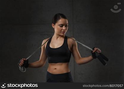 sport, fitness, training, stamina and people concept - young sporty woman with jumping rope
