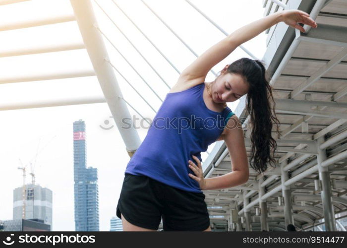 Sport Fitness Woman stretching body exercise in modern city wear wellness sportswear outside. Young woman workout outdoor exercising on bright sunny outside. Healthy wellness lifestyle woman concept.