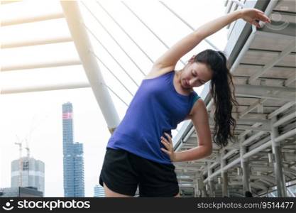 Sport Fitness Woman stretching body exercise in modern city wear wellness sportswear outside. Young woman workout outdoor exercising on bright sunny outside. Healthy wellness lifestyle woman concept.