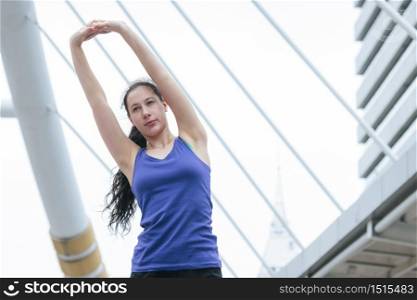 Sport Fitness Women running exercise in modern city wear wellness sportswear outside. Young woman workout outdoor exercising on bright sunny outside. Healthy wellness lifestyle woman concept.