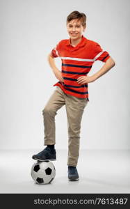 sport, football and leisure games concept - happy boy with soccer ball over grey background. happy boy with soccer ball