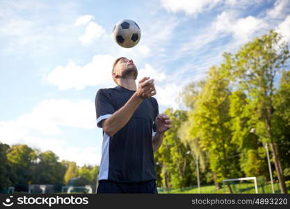 sport, football and people - soccer player playing and juggling ball using header technique on field