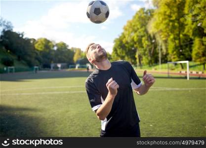 sport, football and people - soccer player playing and juggling ball using header technique on field. soccer player playing with ball on field