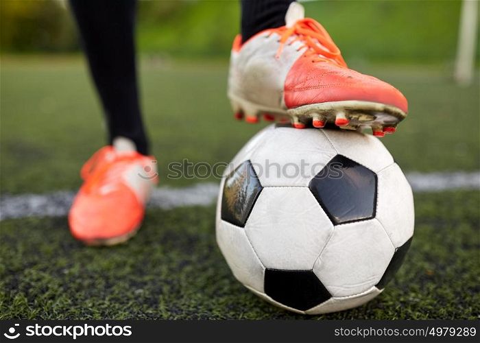 sport, football and people - soccer player playing with ball on field. soccer player playing with ball on football field