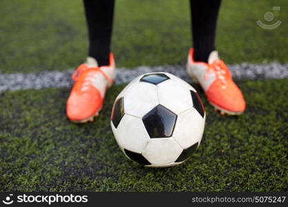 sport, football and people - soccer player playing with ball on field. soccer player playing with ball on football field