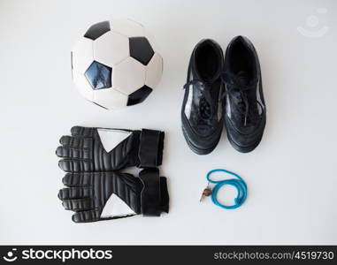 sport, football and sports equipment concept - close up of soccer ball, whistle, gloves and boots
