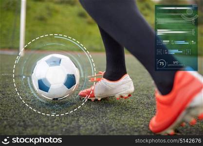 sport, football and technology - soccer player playing with ball on field. soccer player playing with ball on football field