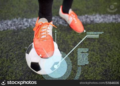 sport, football and technology - soccer player playing with ball on field. soccer player playing with ball on football field