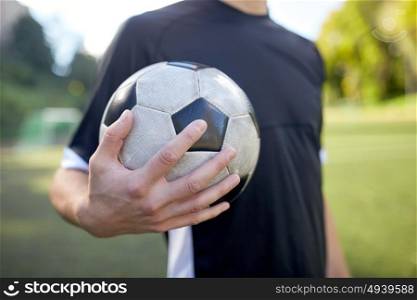 sport, football training and people - close up of soccer player with ball on field. close up of soccer player with football on field