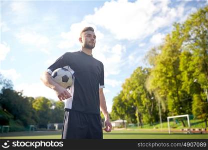 sport, football training and people - soccer player with ball on field. soccer player with ball on football field