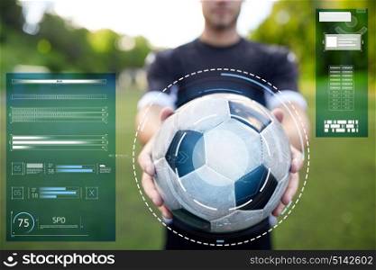 sport, football training and technology - soccer player hands holding ball on field. soccer player with ball on football field