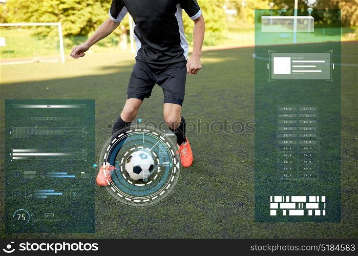 sport, football training and technology - soccer player playing with ball on field. soccer player playing with ball on football field
