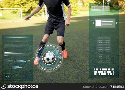 sport, football training and technology - soccer player playing with ball on field. soccer player playing with ball on football field