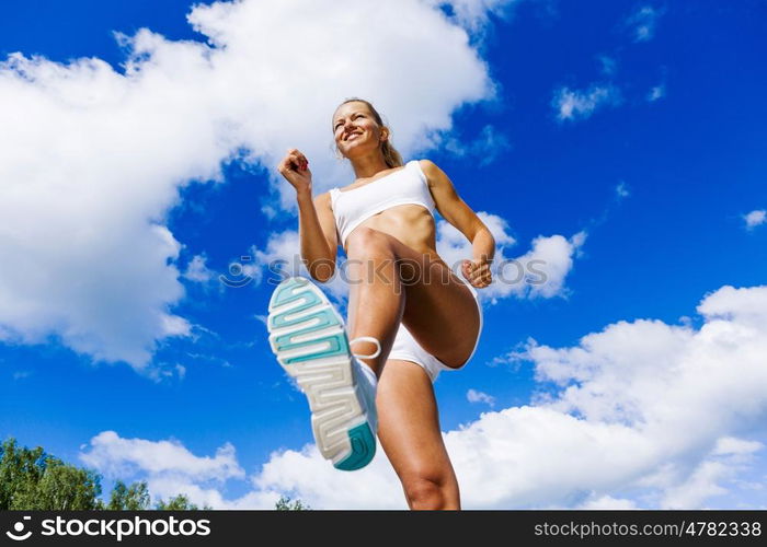 Sport girl. Bottom view of sport girl in white wear running