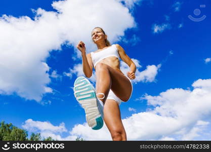 Sport girl. Bottom view of sport girl in white wear running