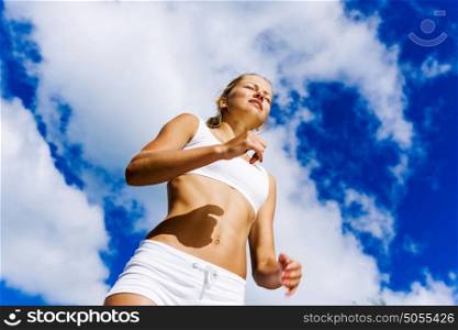 Sport girl. Bottom view of sport girl in white wear running