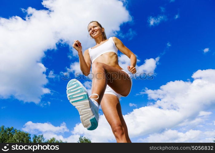 Sport girl. Bottom view of sport girl in white wear running