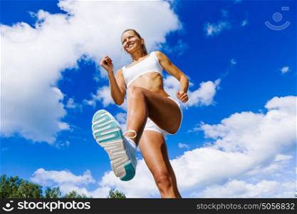 Sport girl. Bottom view of sport girl in white wear running