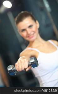 Sport girl. Image of fitness girl in gym exercising with dumbbells