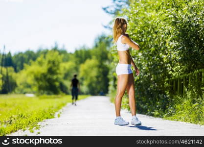 Sport girl. Image of young attractive woman running outdoor