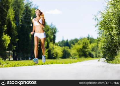 Sport girl. Image of young attractive woman running outdoor