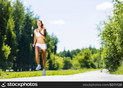 Sport girl. Image of young attractive woman running outdoor