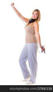 Sport girl plus size doing exercise with skip jump rope - weight loss. Fitness young woman with headphones listening to music isolated. Studio shot.