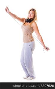 Sport girl plus size doing exercise with skip jump rope - weight loss. Fitness young woman with headphones listening to music isolated. Studio shot.