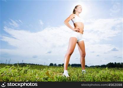 Sport girl. Young beautiful girl training outdoor in summer
