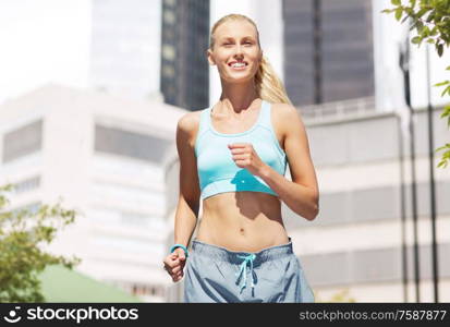 sport, healthy lifestyle and people concept - smiling young woman with fitness tracker running over city street on background. smiling young woman running at city