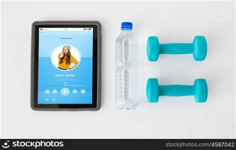 sport, healthy lifestyle, fitness, technology and objects concept - close up of tablet pc computer with dumbbells and water bottle over white background