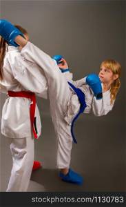 Sport Karate fight two little girls in white kimono in red one second in blue protective kits. two girls are fighting