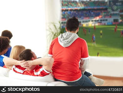 sport, leisure and entertainment concept - friends or football fans watching soccer game on projector screen at home. friends or football fans watching soccer at home. friends or football fans watching soccer at home