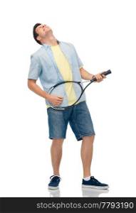 sport, leisure and people concept - happy young man playing tennis racket as imaginary guitar over white background. happy young man playing tennis racket as guitar