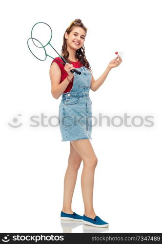 sport, leisure and people concept - smiling teenage girl with badminton rackets and shuttlecock over white background. teenager with badminton rackets and shuttlecock