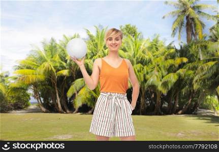 sport, leisure and people concept - smiling teenage girl with volleyball over tropical beach background in french polynesia. smiling teenage girl with volleyball