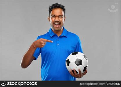 sport, leisure games and people concept - happy indian man or football fan with soccer ball over grey background. indian man or football fan with soccer ball