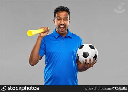 sport, leisure games and success concept - emotional indian man or football fan with soccer ball and vuvuzela over grey background. male football fan with soccer ball and vuvuzela