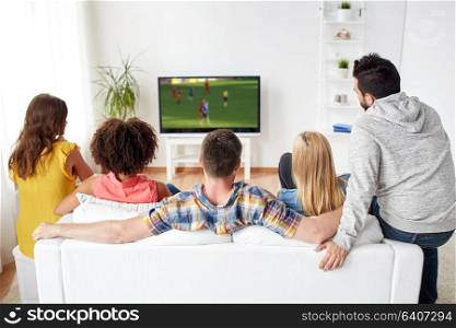 sport, people and entertainment concept - friends or football fans watching soccer game on tv at home. friends watching soccer game on tv at home