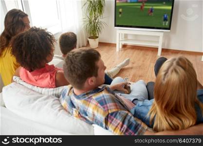 sport, people and entertainment concept - friends or football fans watching soccer game on tv at home. friends watching soccer game on tv at home