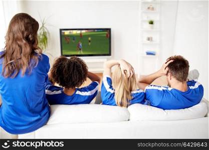 sport, people and entertainment concept - friends or football fans watching soccer game on tv at home. football fans watching soccer on tv at home