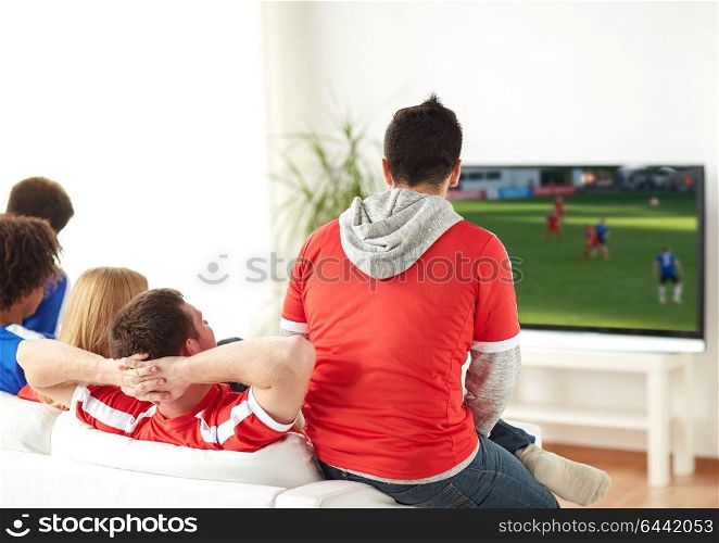 sport, people and entertainment concept - friends or football fans watching soccer game on tv at home. football fans watching soccer game on tv at home