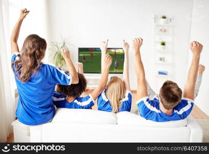 sport, people and entertainment concept - happy friends or football fans watching soccer game on tv and celebrating victory at home. football fans watching soccer game on tv at home