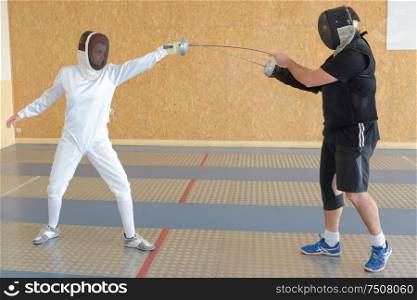 sport people and the fencing lesson