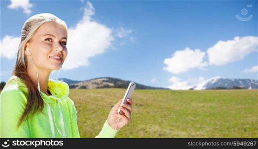 sport, people, fitness, technology and lifestyle concept - woman with smartphone and earphones doing sports and listening to music over natural background