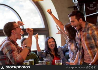 sport, people, leisure, friendship and entertainment concept - happy football fans or friends drinking beer and celebrating victory at bar or pub. football fans or friends with beer at sport bar