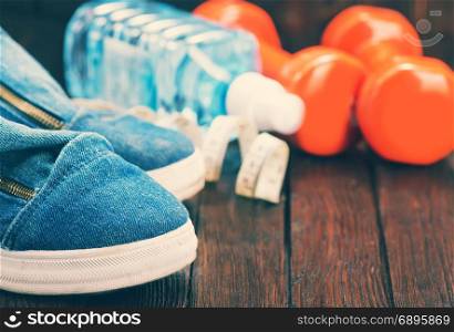 sport shoes and water on the wooden table