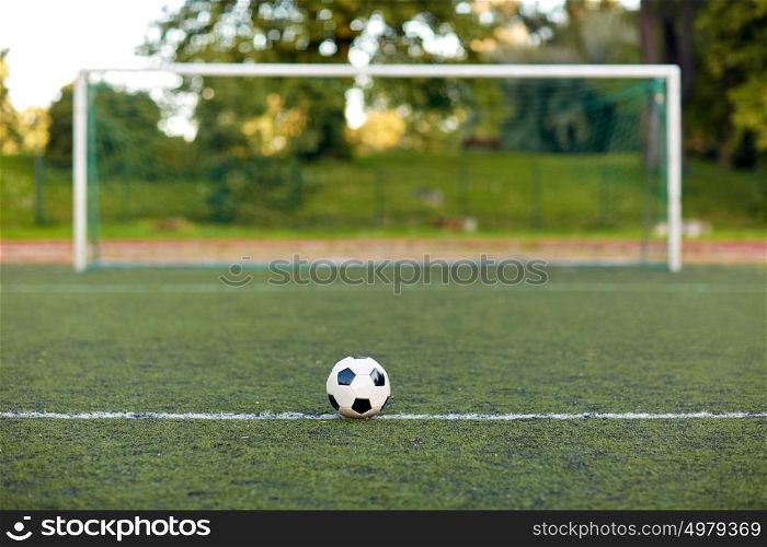 sport, soccer and game - ball and goal on football field. soccer ball and goal on football field